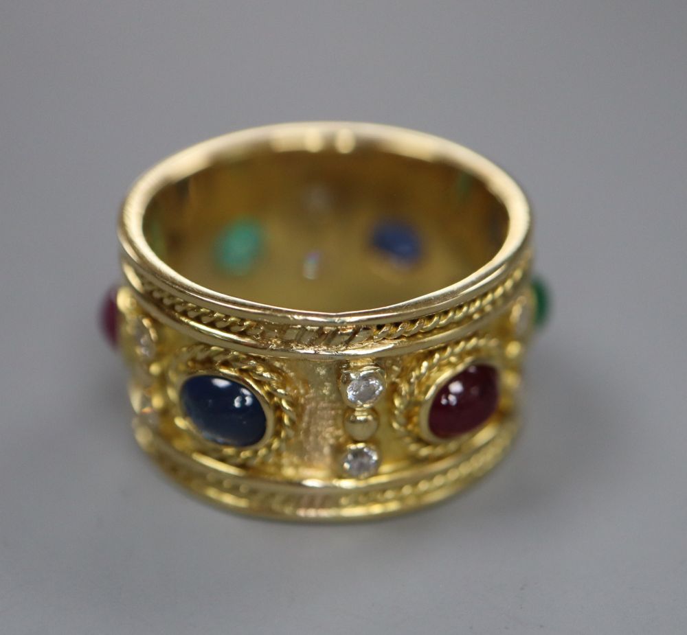A modern yellow metal, diamond and cabochon ruby, sapphire and emerald set band, signed Alex, size S, gross 11.4 grams.